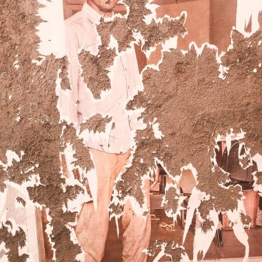 A vintage photograph of a man showing notable peeling damage and texture.